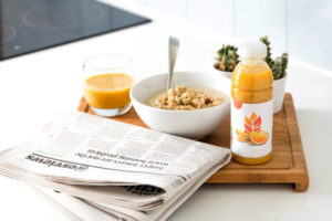 a newspaper and a breakfast tray