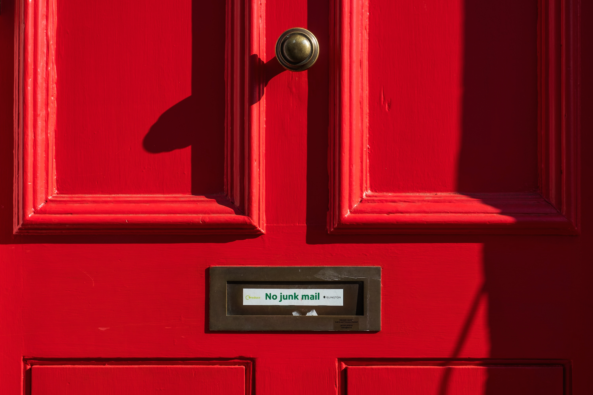 photo of a red door with no junk mail written on it to illustrate using email for your cannabis business, but not spamming